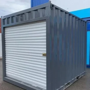 Dunkelgrauer 10′-Lagercontainer mit weißem Rollladen an der Stirnseite, abgestellt auf einem Containerplatz