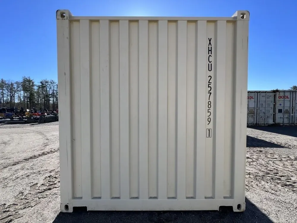 Stirnwand aus Trapezblech mit senkrecht aufgemalter Containernummer, beiger Lagercontainer