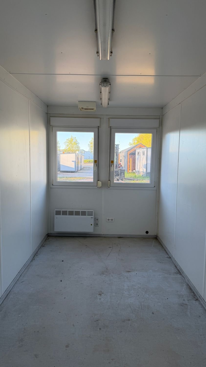 Fensterfront mit Heizkörper und Steckdosen im Inneren des Büro- und Mannschaftscontainers